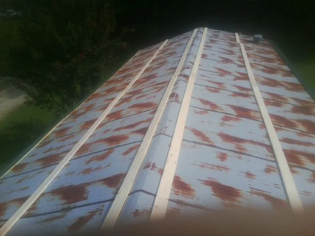 Rusted metal roof panels with new wood purlins before replacement — Storm Damage Roof Repair in Ivoryton by Roofing Brothers