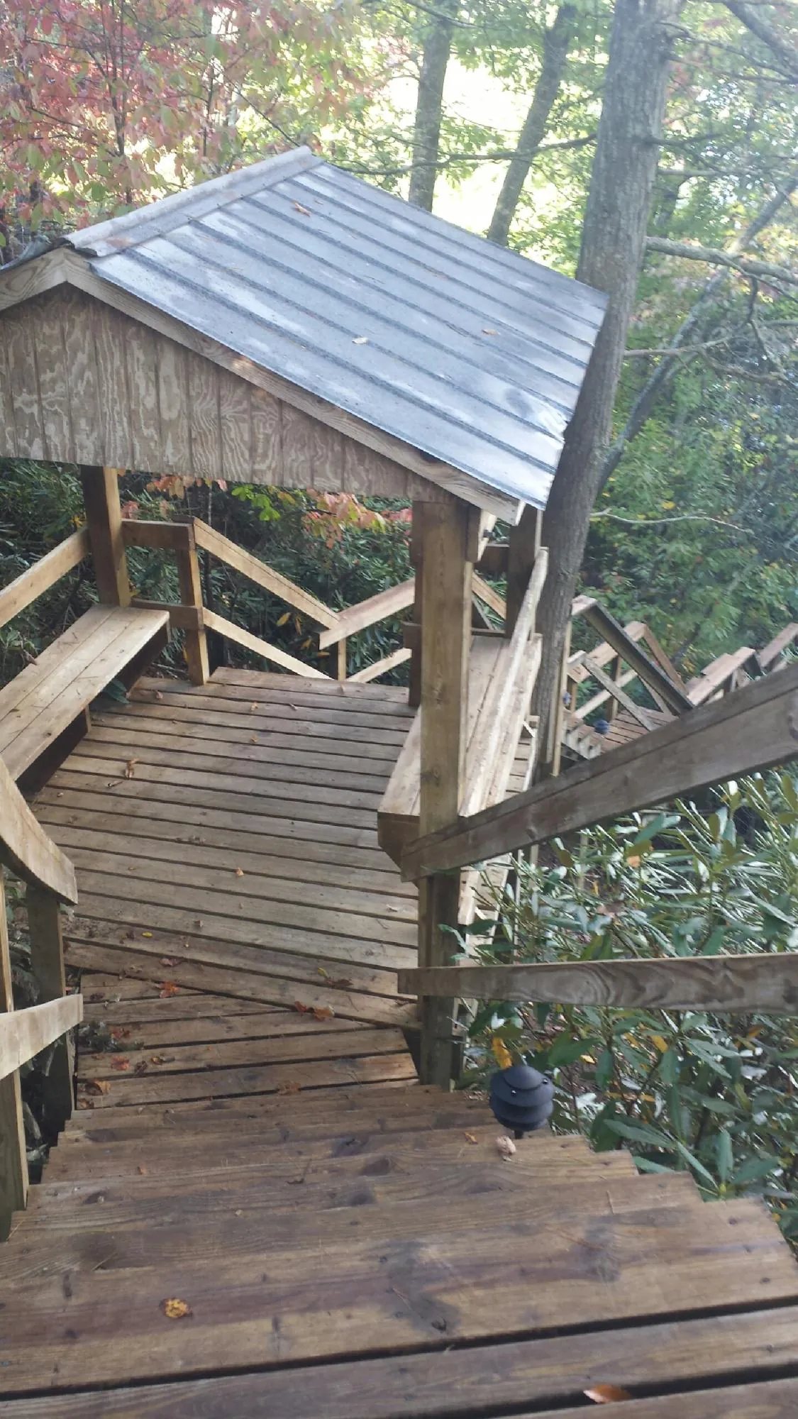 Metal roofed shelter over wooden steps on a wooded walkway — Skylight Repair & Installation work by our crew in Ivoryton