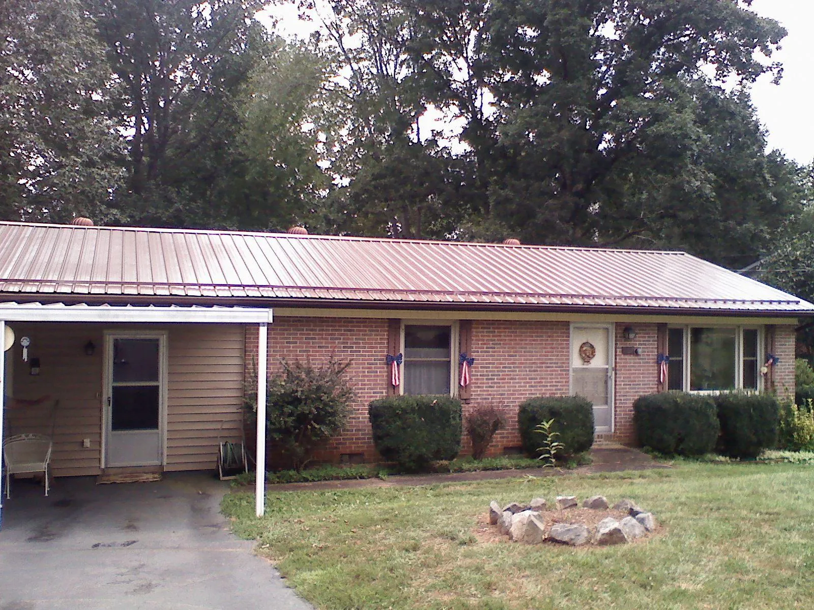 Bronze metal roof and carport on a brick ranch home — Roof Repair work by our crew in Ivoryton