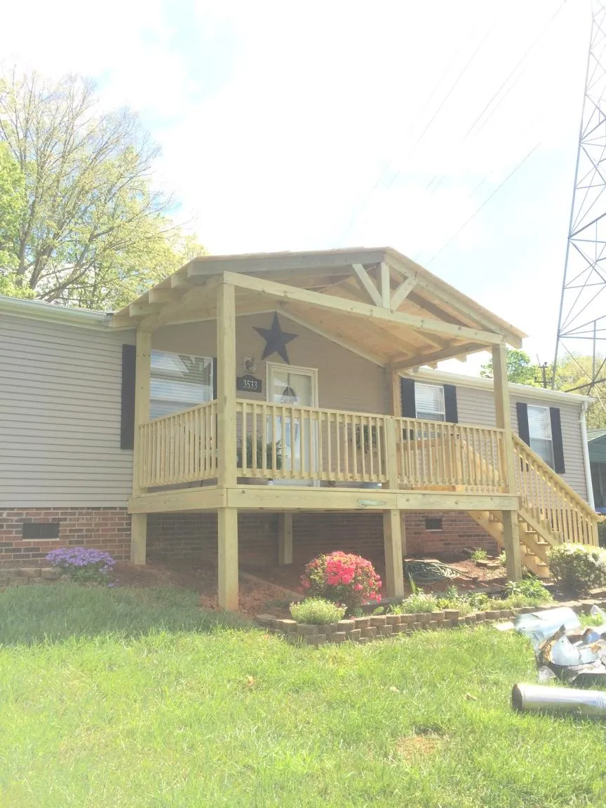 New gabled porch roof and deck railing added to a ranch home in Ivoryton